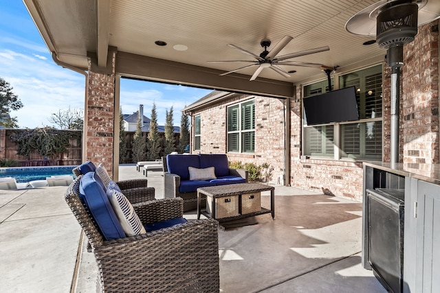 view of patio / terrace with a fenced in pool, an outdoor hangout area, and ceiling fan