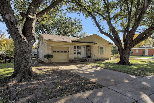 ranch-style house featuring a garage and a front yard