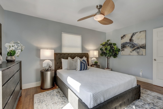 bedroom with ceiling fan and hardwood / wood-style flooring