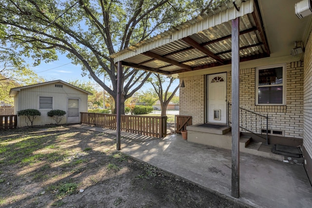 view of patio featuring an outbuilding