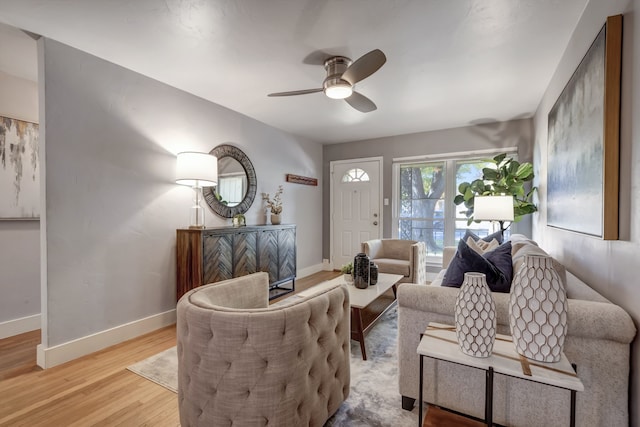 living room featuring light hardwood / wood-style floors and ceiling fan