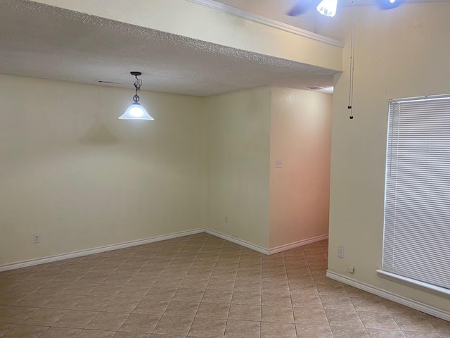 unfurnished room featuring a textured ceiling