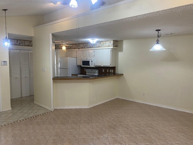 kitchen with white cabinetry, white appliances, kitchen peninsula, and a textured ceiling