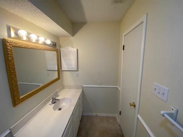 bathroom featuring vanity and a textured ceiling