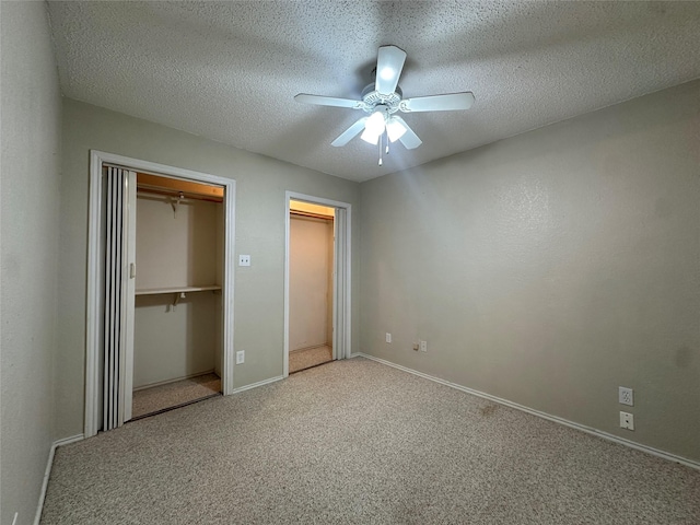 unfurnished bedroom with ceiling fan, carpet flooring, and a textured ceiling