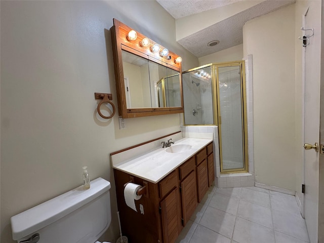 bathroom featuring toilet, a textured ceiling, walk in shower, tile patterned flooring, and vanity