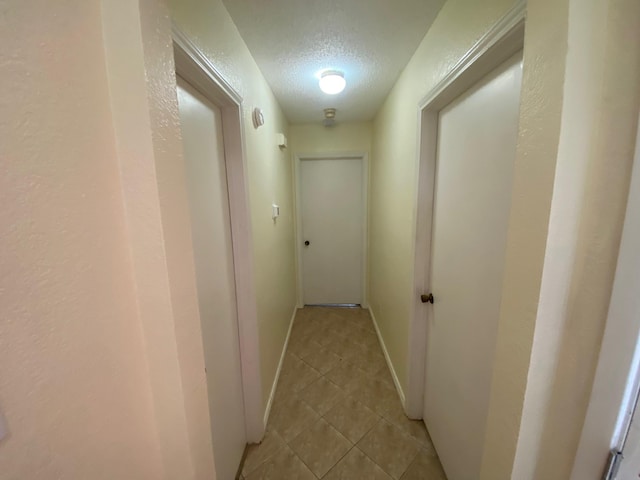 corridor featuring a textured ceiling