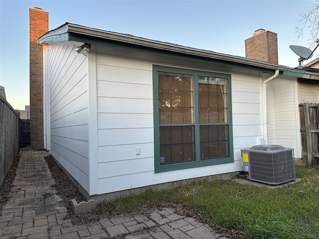 view of side of home with central AC unit