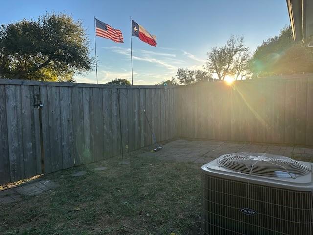 yard at dusk with central air condition unit