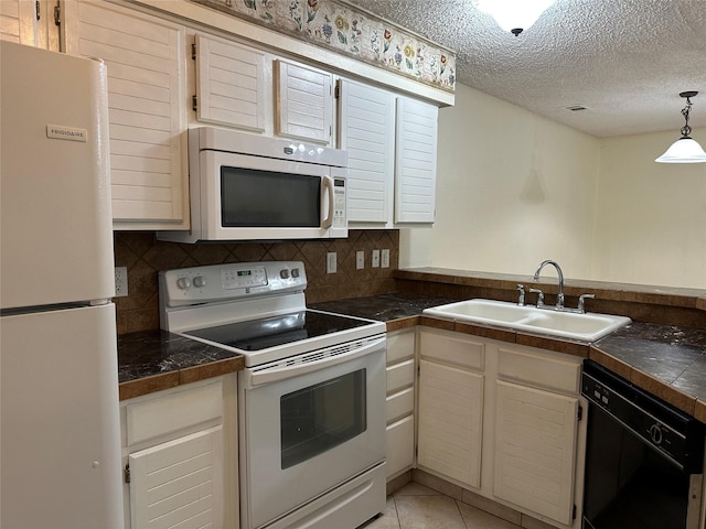 kitchen with sink, white appliances, tasteful backsplash, and light tile patterned floors