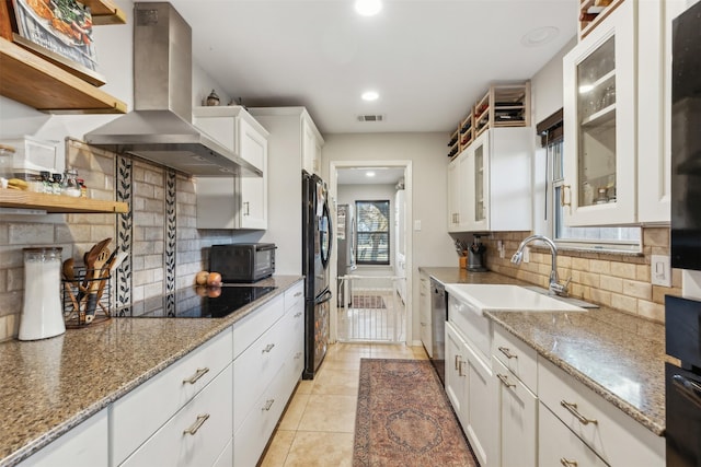 kitchen featuring sink, white cabinets, light stone countertops, black appliances, and island range hood