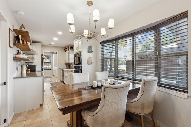 dining area featuring a notable chandelier, a wealth of natural light, and light tile patterned floors