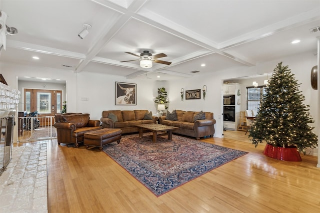 living room featuring light hardwood / wood-style flooring, beam ceiling, and coffered ceiling