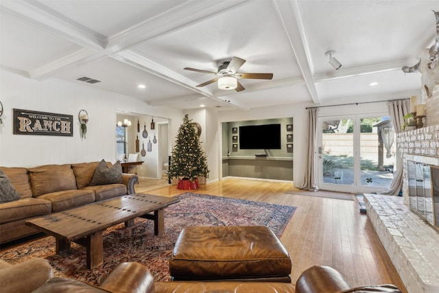 living room featuring coffered ceiling, beam ceiling, and light wood-type flooring