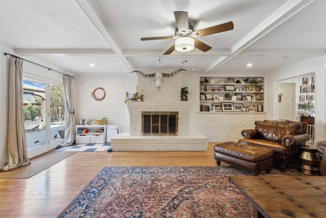 living room featuring coffered ceiling, beamed ceiling, and light hardwood / wood-style floors