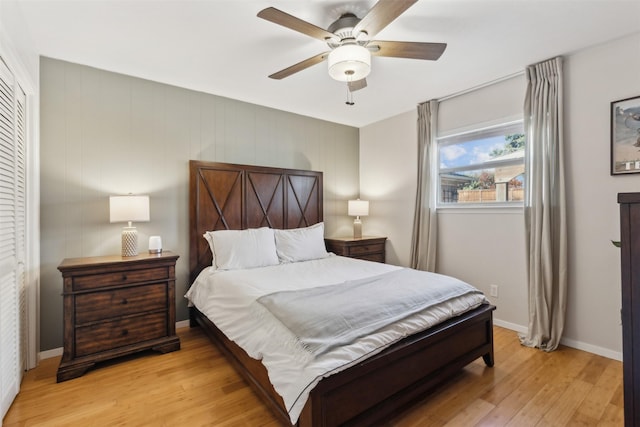 bedroom featuring ceiling fan, a closet, and light wood-type flooring