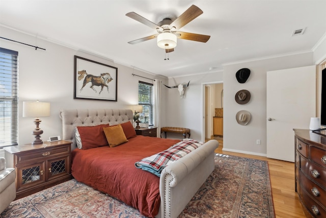 bedroom featuring light hardwood / wood-style floors, ceiling fan, and ornamental molding