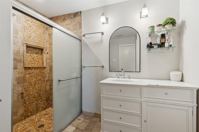 bathroom featuring vanity and tiled shower