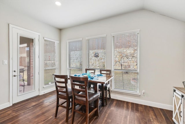 dining space with dark hardwood / wood-style floors and lofted ceiling