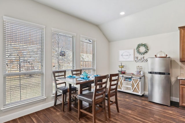 dining area featuring dark hardwood / wood-style floors and lofted ceiling