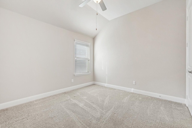 spare room featuring ceiling fan, carpet, and lofted ceiling