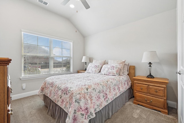 carpeted bedroom with ceiling fan and vaulted ceiling