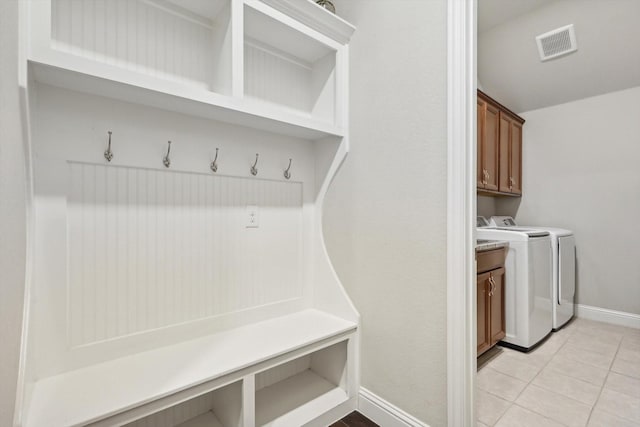 mudroom featuring separate washer and dryer and light tile patterned floors