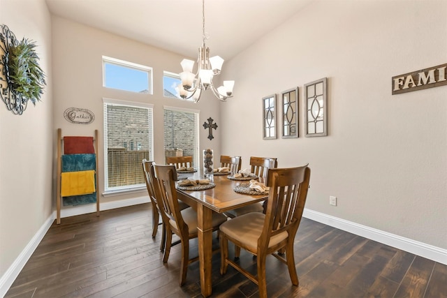 dining area featuring a high ceiling, dark hardwood / wood-style flooring, and a notable chandelier