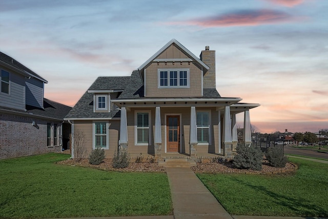 view of front of house featuring a lawn and a porch