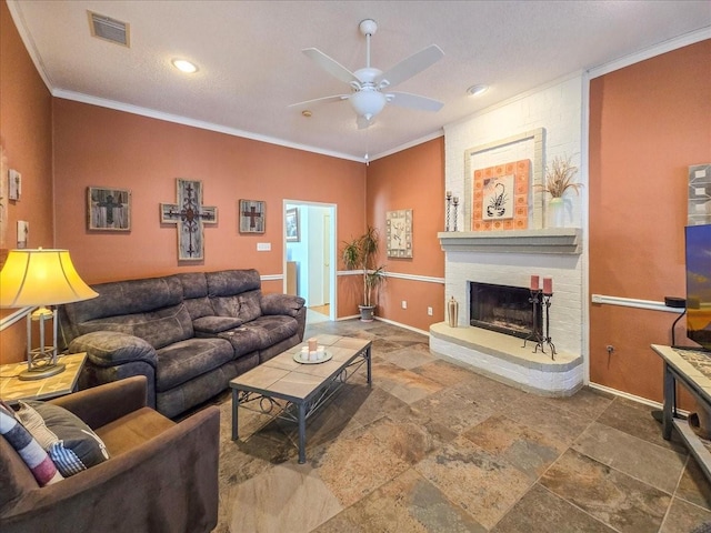 living room with a brick fireplace, ornamental molding, and ceiling fan