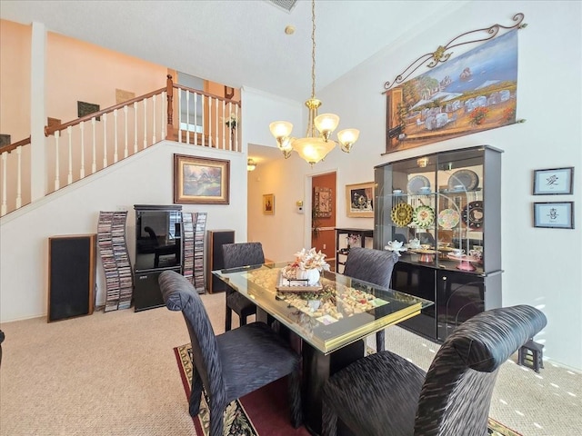 carpeted dining room featuring high vaulted ceiling and a notable chandelier