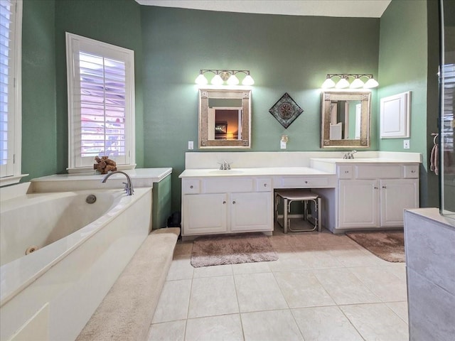 bathroom with a tub, tile patterned floors, and vanity