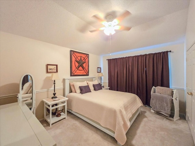 bedroom featuring light carpet and ceiling fan