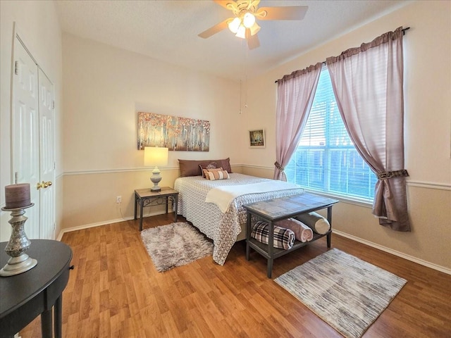 bedroom with hardwood / wood-style floors and ceiling fan