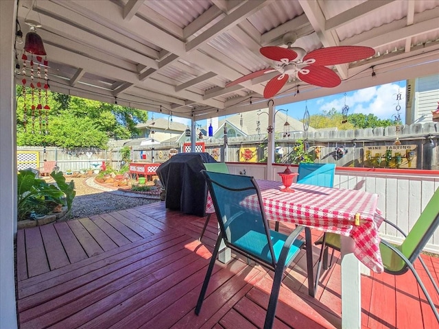 deck featuring area for grilling and ceiling fan