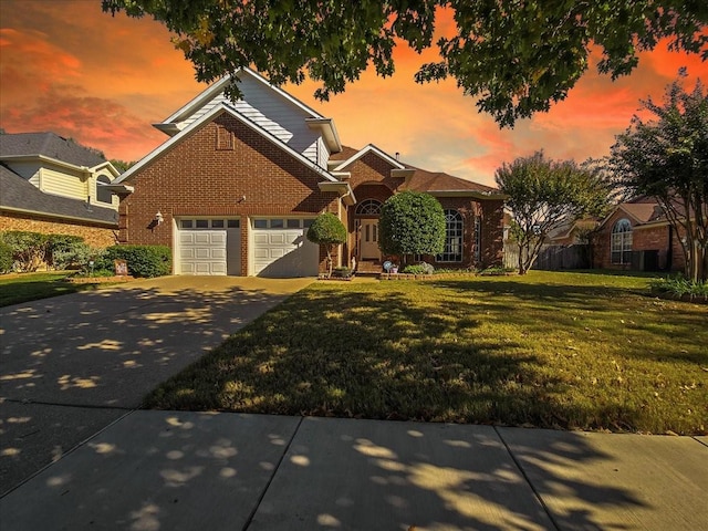 front facade with a garage and a yard