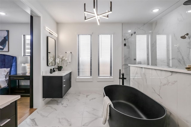 bathroom featuring vanity and separate shower and tub