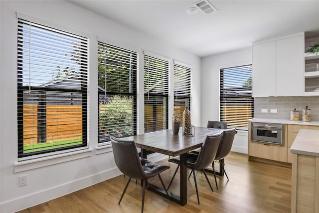 dining space featuring a healthy amount of sunlight and light wood-type flooring