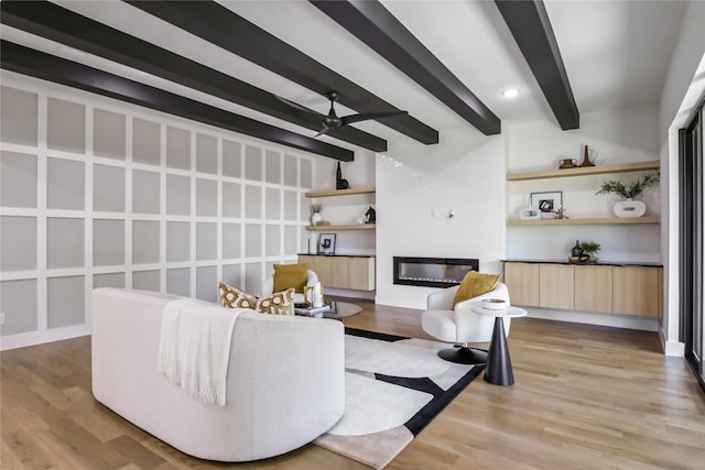 living room featuring light hardwood / wood-style floors, beam ceiling, and ceiling fan