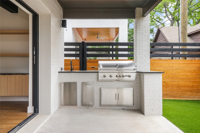 view of patio featuring area for grilling, sink, ceiling fan, and a grill