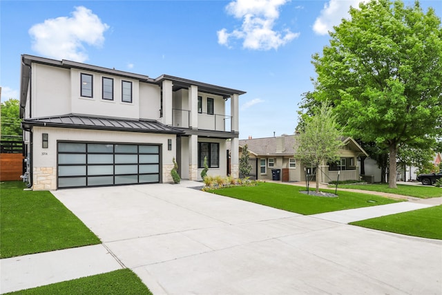 view of front of house with a balcony, a garage, and a front lawn