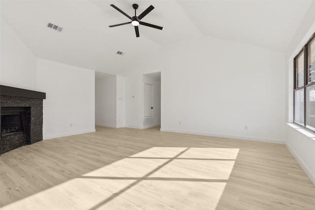 unfurnished living room with light hardwood / wood-style floors, ceiling fan, and vaulted ceiling