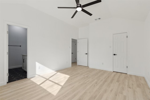 unfurnished bedroom with lofted ceiling, light hardwood / wood-style flooring, connected bathroom, and ceiling fan