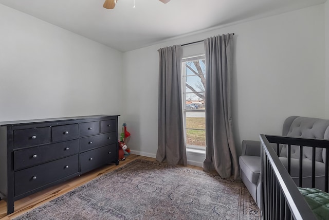 bedroom with ceiling fan and light hardwood / wood-style flooring