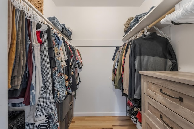 spacious closet with light hardwood / wood-style floors