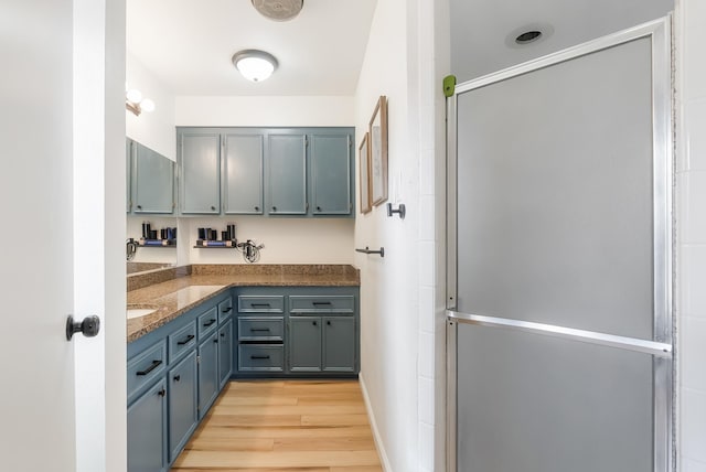 kitchen featuring light hardwood / wood-style flooring and dark stone counters