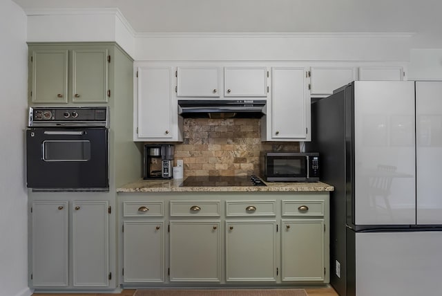 kitchen featuring black appliances and backsplash