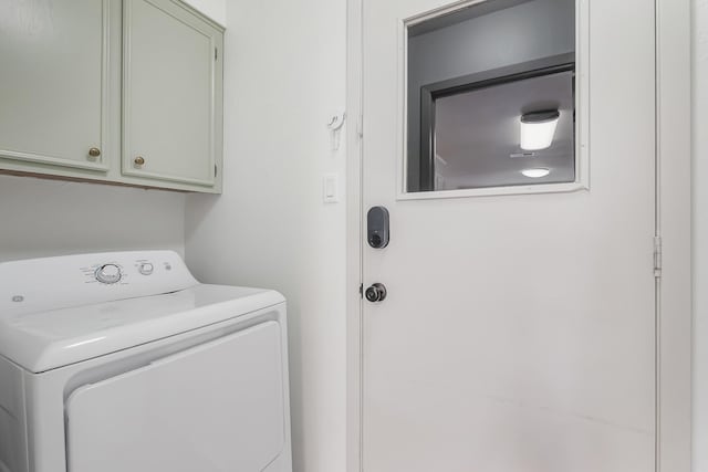 washroom featuring cabinets and washer / dryer