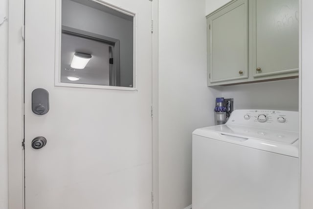 washroom featuring cabinets and washer / dryer