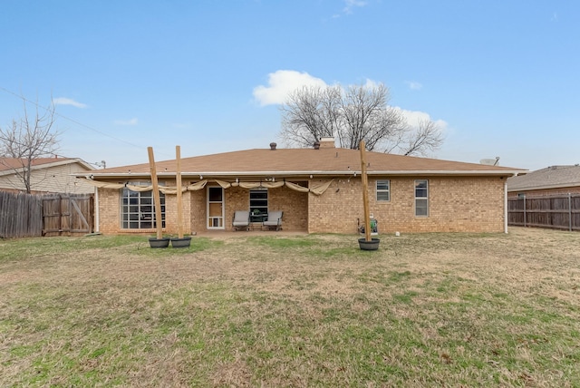 rear view of property with a lawn